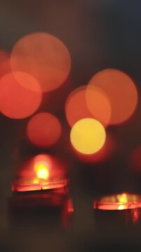 Red blurry light from candles in the church - bokeh effect
