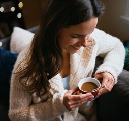 Smile, relax and coffee with woman on sofa in home for winter beverage, weekend break and health. Caffeine drink, happiness and peace with female person and mug in living room of apartment for tea