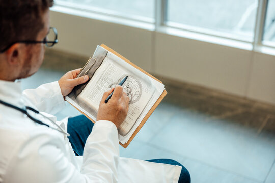 Doctor analyzing brain scan x-ray at hospital