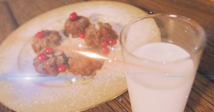 Showing milk glass resting on wooden dining table with sugared fritters and red berries, copy space
