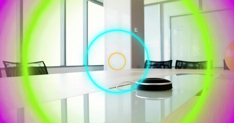 Naklejka premium Showing small speaker puck with cable reflecting on glossy table in meeting room, colored rings