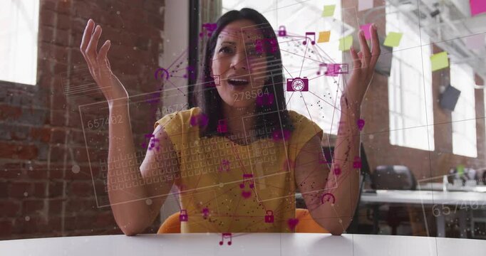 Woman gesturing and speaking in creative studio causing magenta overlay in front mapping tech data