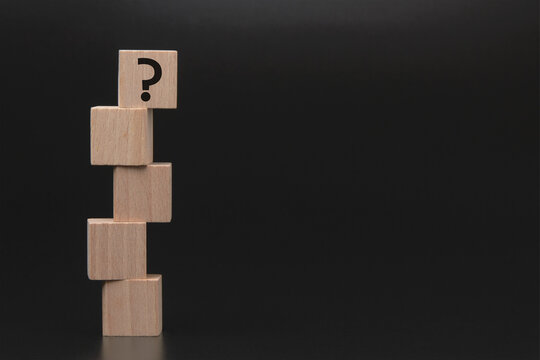 Question mark on wooden blocks representing uncertainty and decision making
