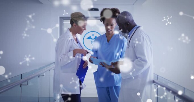 Medical team reviewing charts after nurse tapping tablet molecular overlaying team confirming care