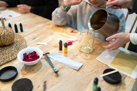 Pouring soy wax for handmade candle making workshop