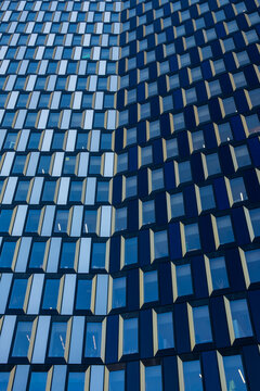 Contemporary abstract architecture facade in blue showing modular cladding texture pattern with geometry repetition across clean modern panels