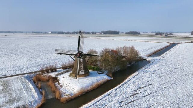 Historic European polder windmill in rural landscape