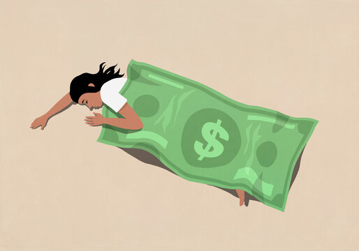 Woman sleeping under large U.S. dollar bill blanket