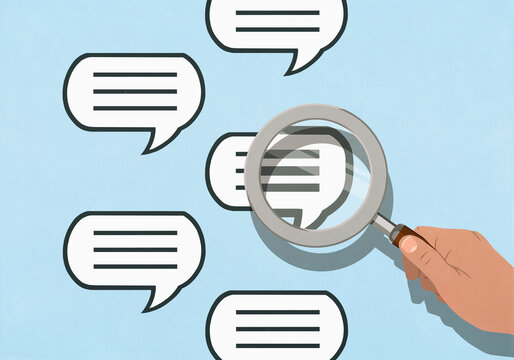 Hand holding magnifying glass over speech bubble text on blue background