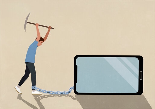 Man with pickaxe breaking chain connecting his ankle to smart phone on beige background