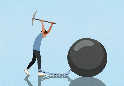 Man with pickaxe trying to break chain connecting his ankle to large bomb