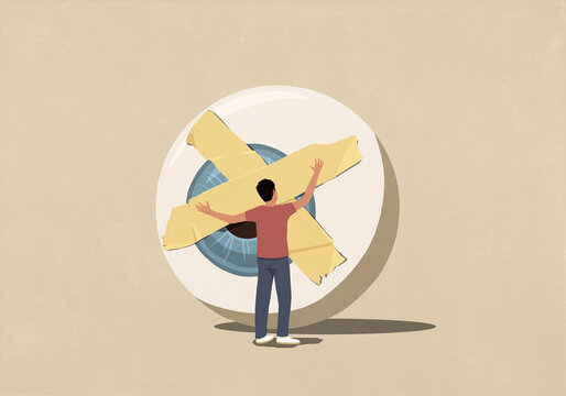 Man placing adhesive tape over large eyeball against beige background