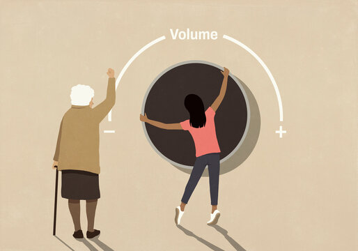 Senior woman with raised fist behind girl turning large volume knob
