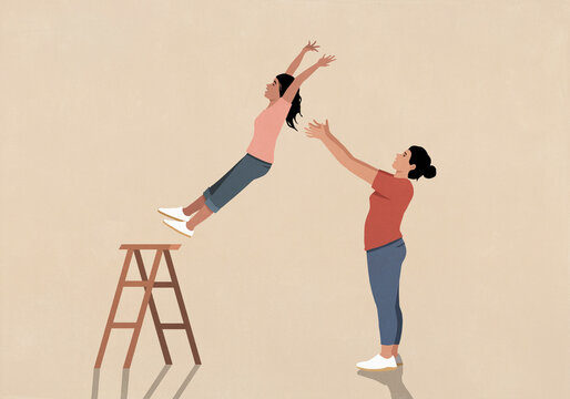 Mother catching daughter in a trust fall against beige background