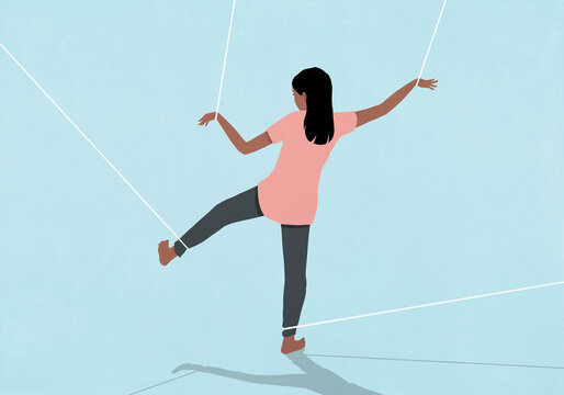 Teenage girl restrained with strings on wrists and ankles trying to walk against blue background