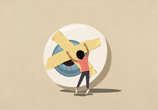 Woman placing adhesive tape over large eyeball against beige background