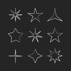 Obraz premium Hand drawn white star shapes with rough chalk outlines on a dark background. Minimal doodle stars in a blackboard style, featuring different star forms and expressive sketch lines. Perfect for school
