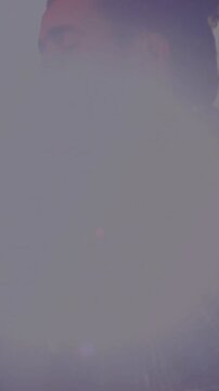 Vertical video: Man singing into retro mic, backlight flaring into haze, fading, revealing singer