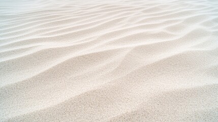 A close-up view of a sandy beach, showcasing the intricate patterns formed by the undulating grains of sand.
