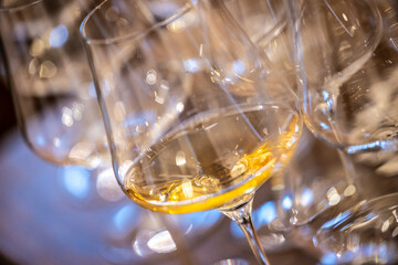a glass of white wine under empty glasses