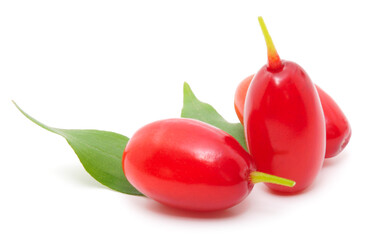 Fresh red cornelian cherry berries with green leaves isolated on white background