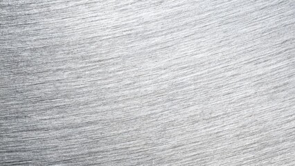 Close-up of a brushed metal surface with silver-gray streaks. Concept Close-up photography, Brushed metal texture, Metallic surface, Silver-gray streaks, Industrial design