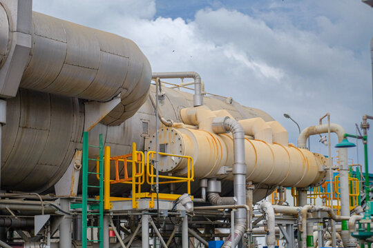 Demineralized water tank and multi effect desalination plant (MED) at industrial power plant. A thermal technology uses steam to produce distilate water from seawater