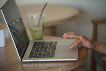 Close-up of hands typing on a laptop keyboard, remote work or digital nomad lifestyle.