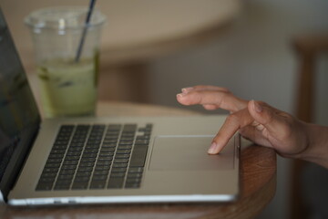 Close-up of hands typing on a laptop keyboard, remote work or digital nomad lifestyle.