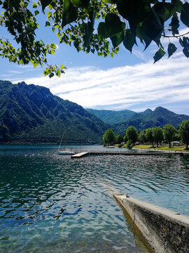 Summer Afternoon at Lake Idro with Sailboat Moored at a Small Pier, Clear Water, Green Mountains and Blue Sky, Brescia, Italy, Europe