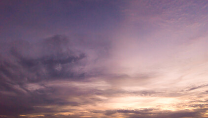 Fototapeta premium Panoramic view of sunset golden and blue sky nature background. Colorful dramatic sky with cloud at sunset.Sky background.Sky with clouds at sunset.