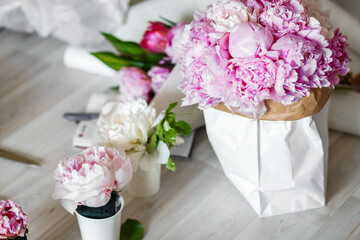 Bouquet of peonies in kraft paper bag