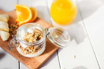 healthy breakfast bowl of yogurt with granola and banana
