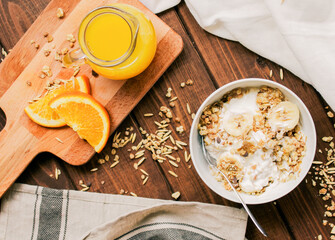 healthy breakfast bowl of yogurt with granola and banana
