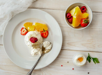 Ice cream with berries on white plate top view