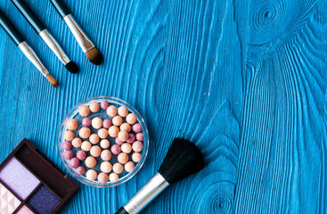 decorative cosmetics on wooden background top view