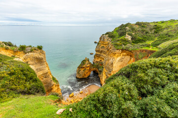 View of the Atlantic Ocean and Green Coastal Landscape in Lagos, Algarve, Portugal © Anna