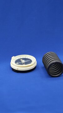 Wrong Compass. Metal spring deflects the compass needle. Minimalism. Shallow Depth of Field.