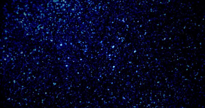 Deep Blue Glitter Loop. Twinkling royal-blue micro-glitter particles gently floating and sparkling against infinite black background.