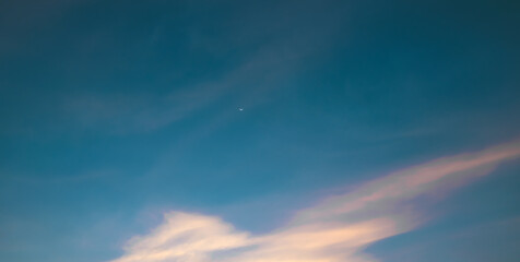 the sky is covered with fluffy pink and white clouds.