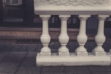 Fototapeta premium Elegant white balustrade supports a charming urban setting in early morning light, showcasing intricate design and craftsmanship