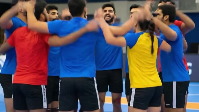A diverse group of young athletic Indian men and women in a huddle, wearing blue, red, and yellow sports jerseys, showing teamwork and unity during a sports competition.