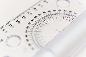 Measuring angles with a transparent protractor on a white surface