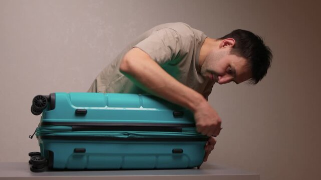 Traveler opening luggage, Close shot of hands unfastening suitcase zipper before travel, Detailed view of hands pulling zipper on vibrant teal travel case with anticipation