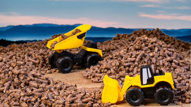 cami&oacute;n y retroexcavadora cargando pellet de madera 