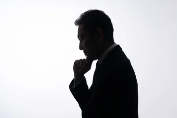 Fotobehang Ridders 悩む男性　シルエット  © naka