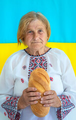 Grandmother is a Ukrainian patriot in an embroidered shirt. selective focus.
