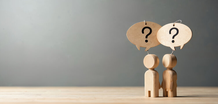 Two wooden figures stand with question marks above heads representing doubt and confusion. They symbolize a team needing solutions for complex problems and seeking answers together.
