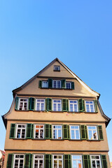 Traditional Yellow Gabled House with Green Shutters in Tubingen Old Town
