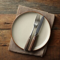Rustic plate with cutlery on wooden table